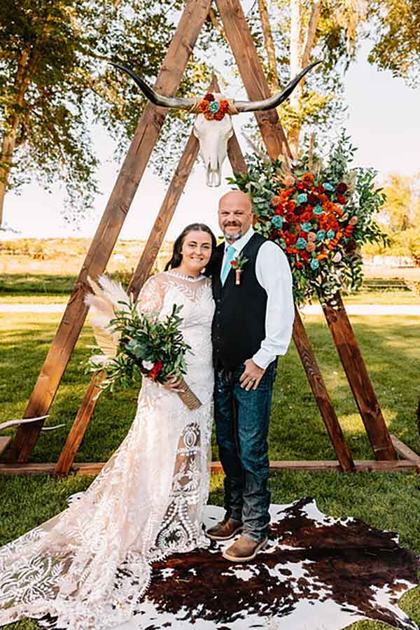 A bride in a rustic lace dress with her father