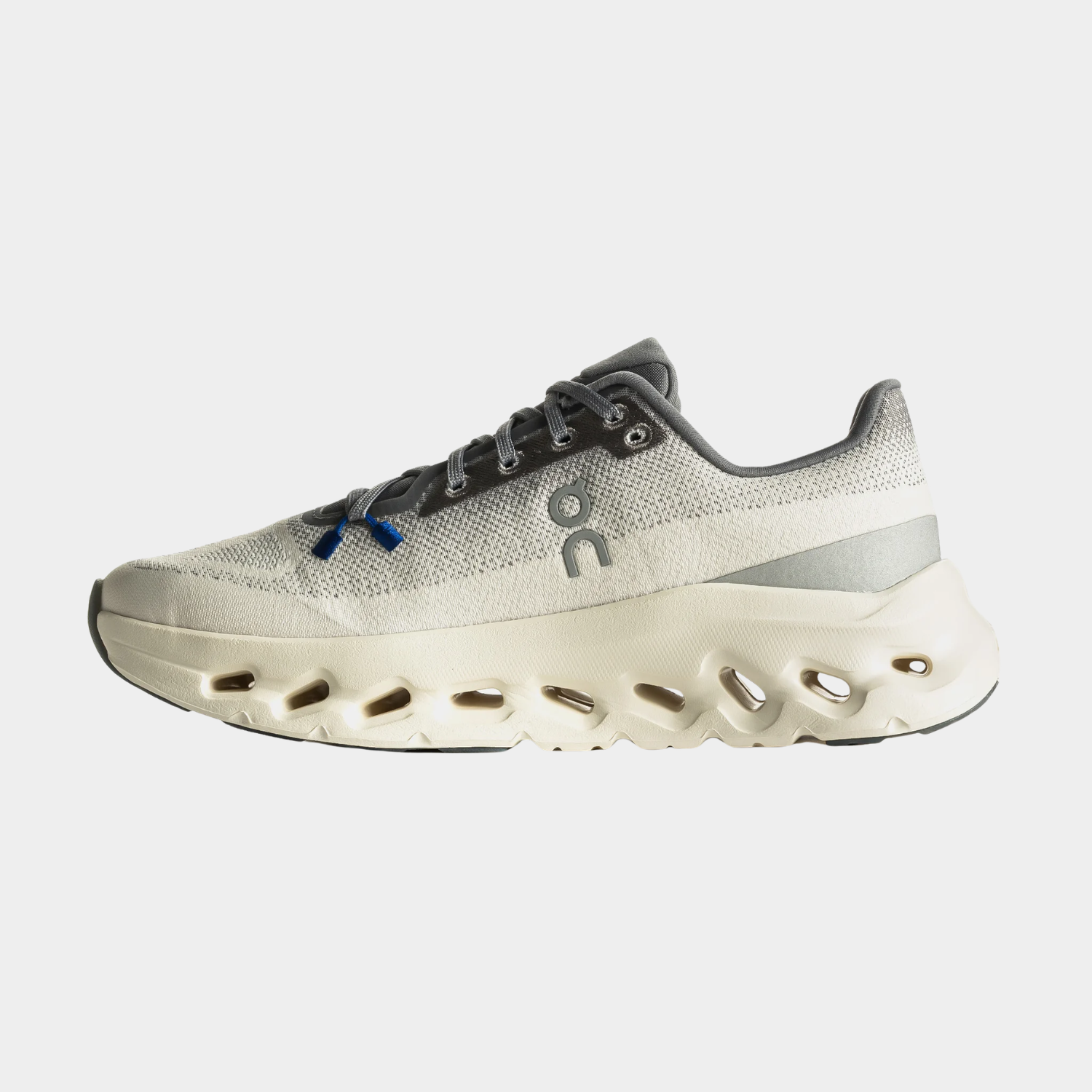 Grey athletic shoe with a unique sole design and blue accents.