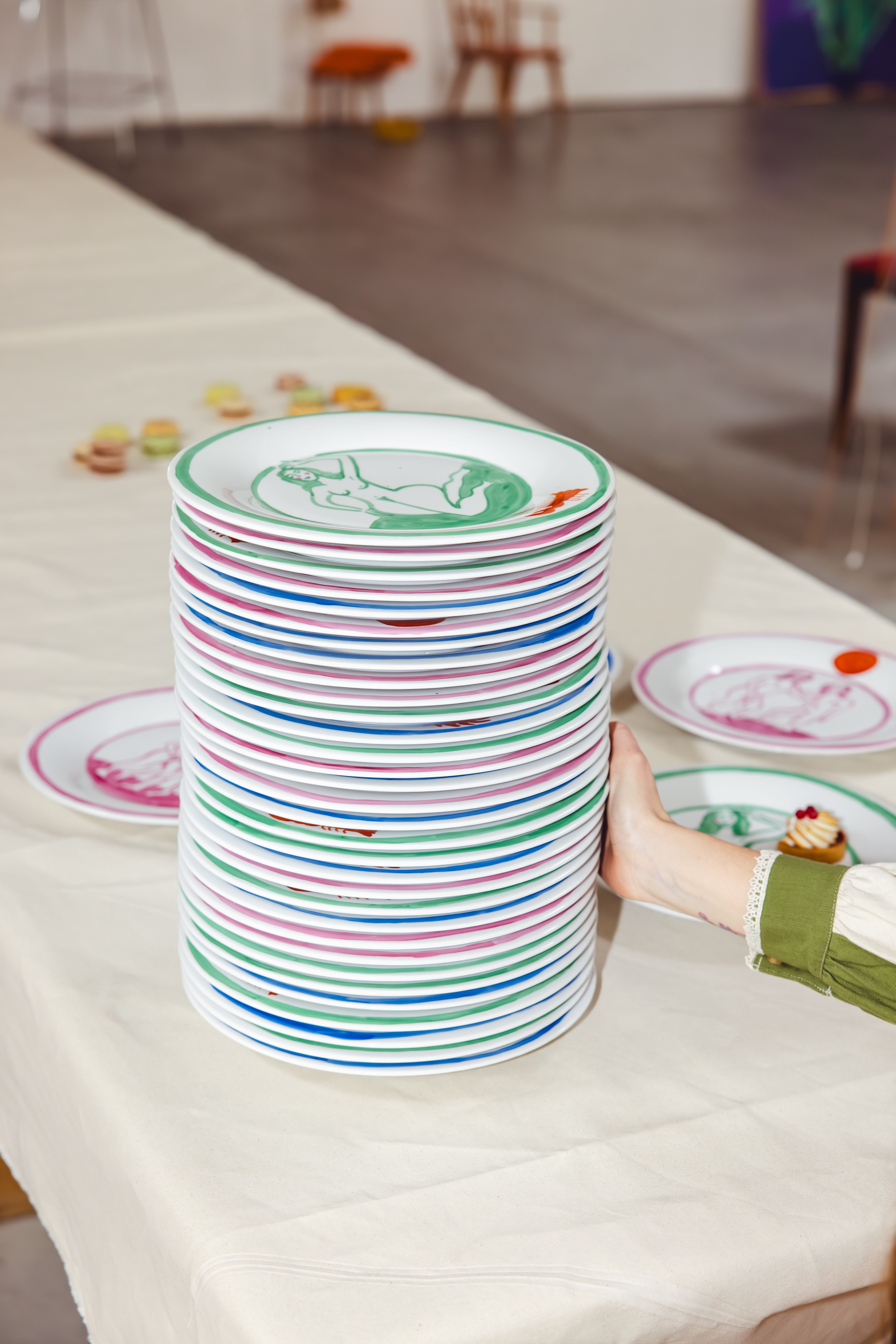 Stack of colorful plates on a table.