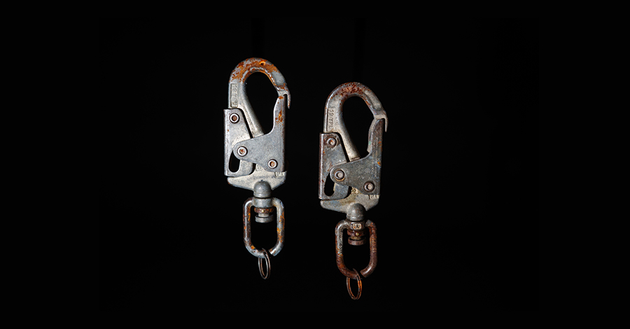This steel snap hook connects an SRL to an anchor. Check that the hook fits the attachment point and will bear the load as intended.