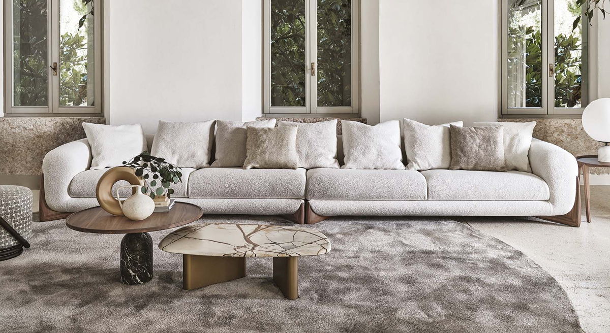 A cozy living room with a Softbay Sofa by Porada and decorative table.