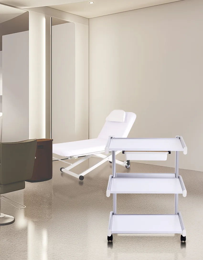 A modern treatment room with a reclining chair and a multi-tiered cart.
