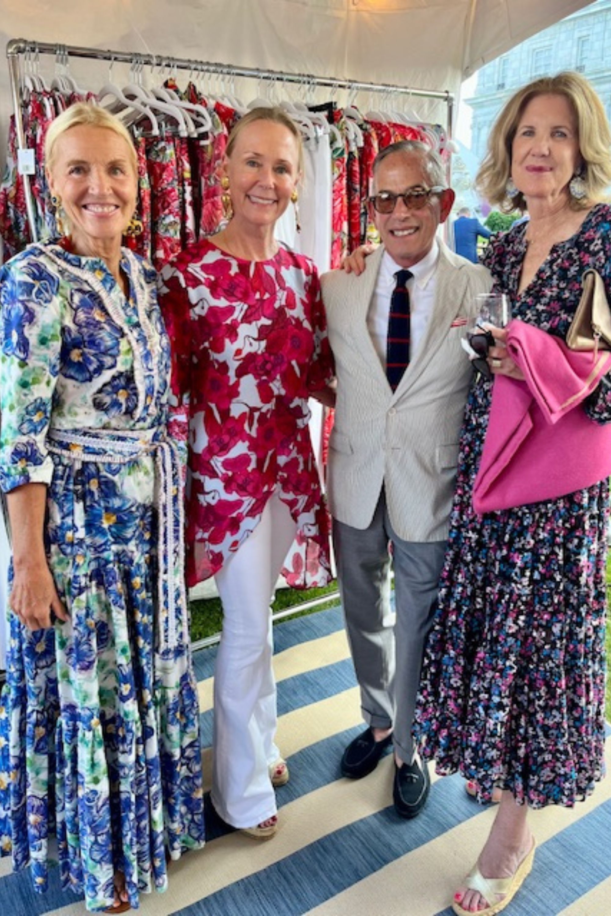 Four individuals posing together in floral outfits by Ala von Auersperg at the Newport Flower Show in Rhode Island at the Breakers Mansion