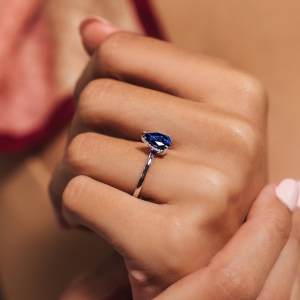Blue sapphire tear drop hidden halo engagement ring in 14k white gold