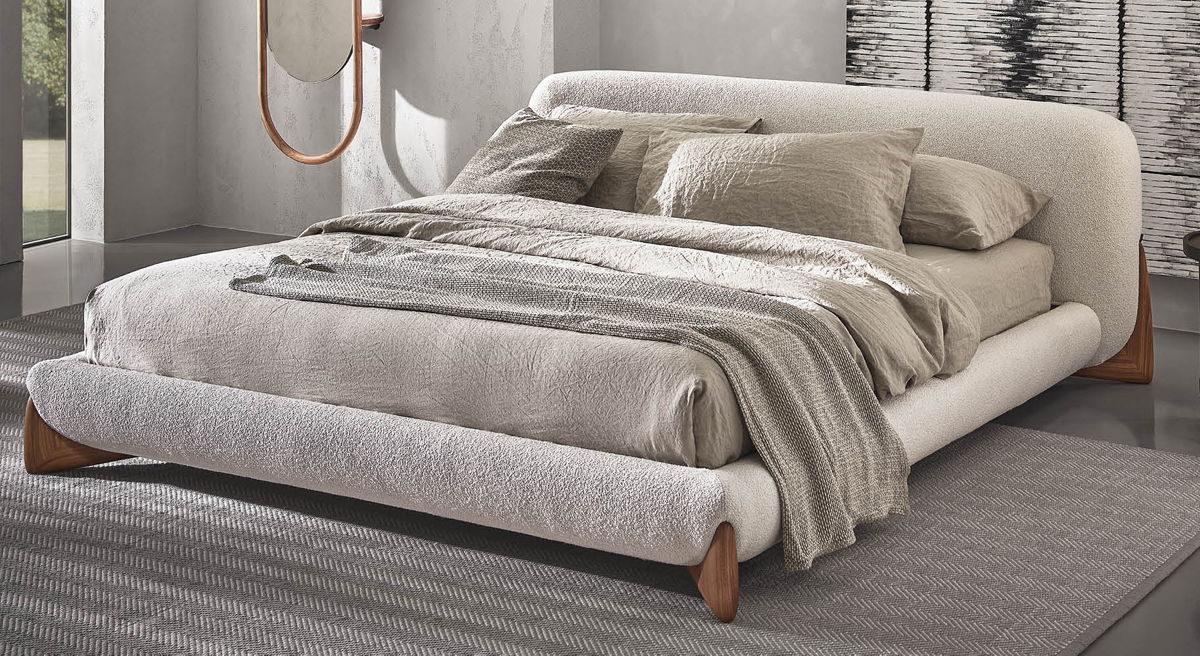 Modern bed with soft linens and elegant design in a stylish bedroom setting.
