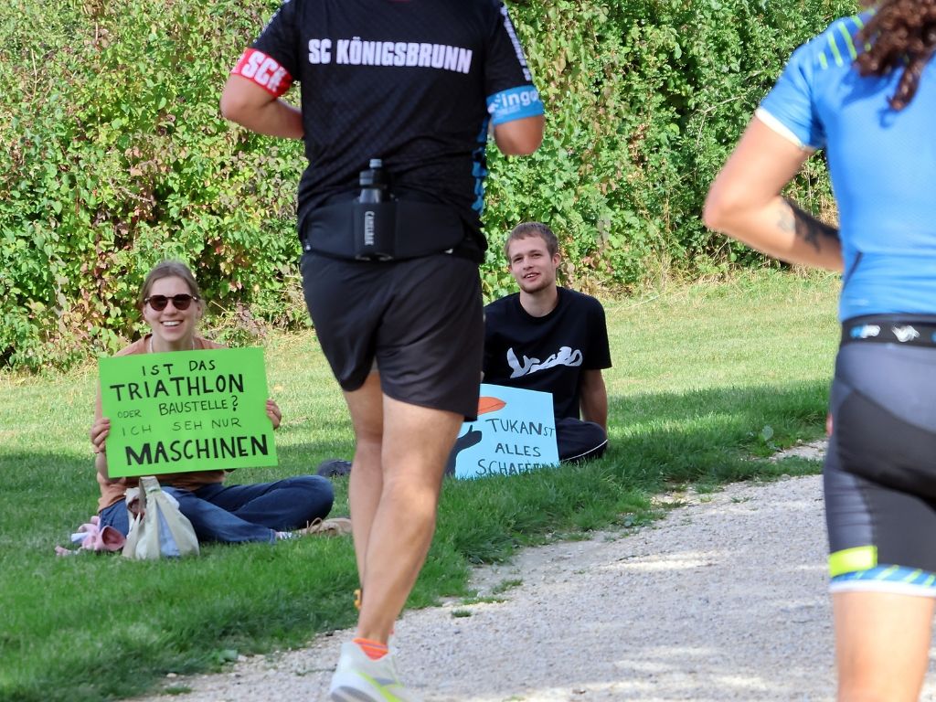 Zuschauern feuern Athleten auf der Laufstrecke an.