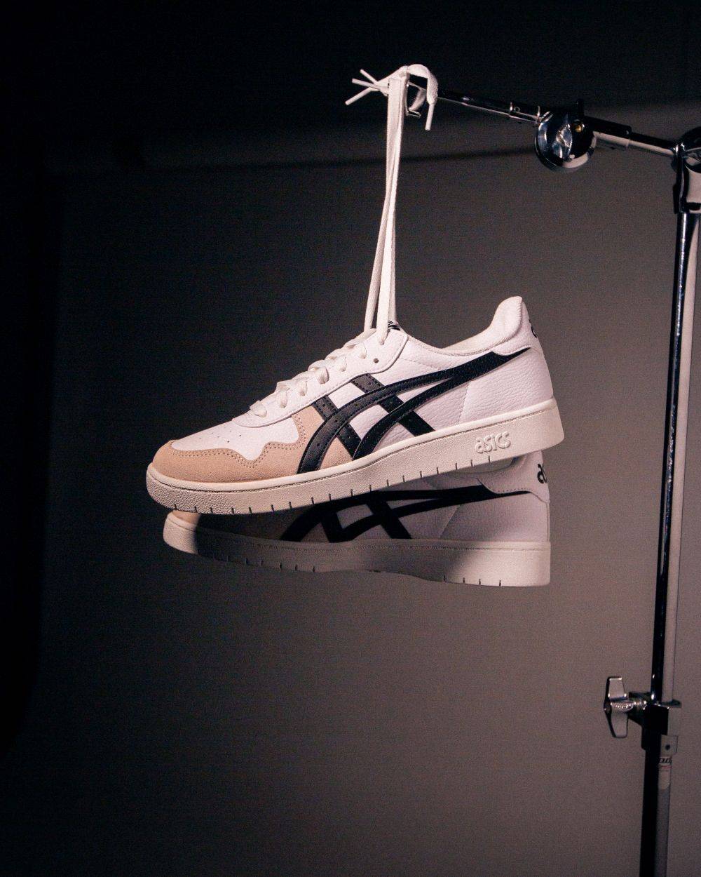 white asics hung from shoelaces