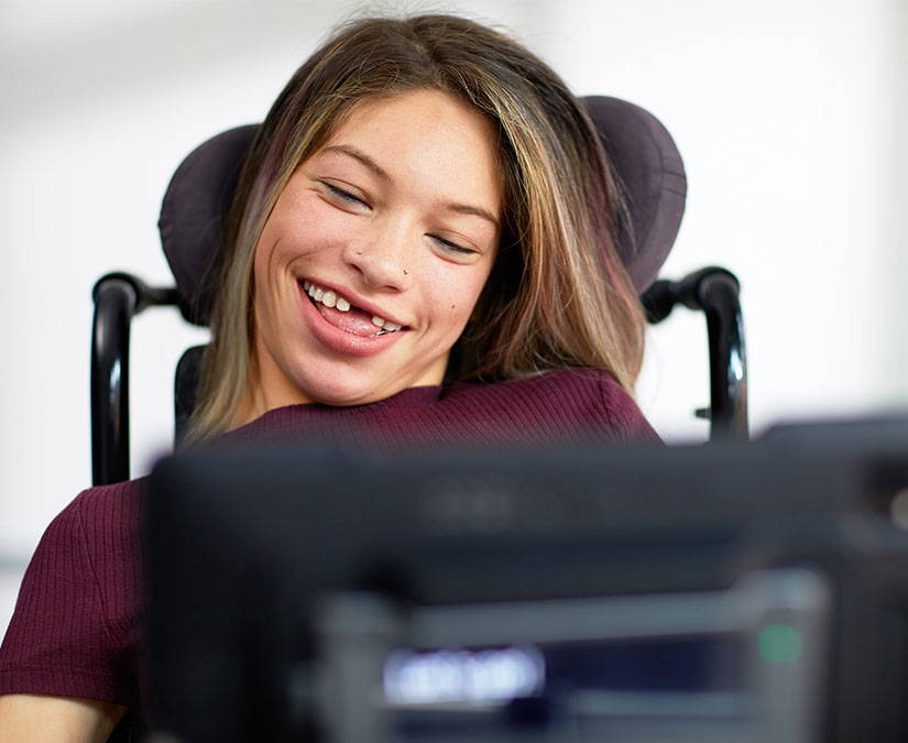 Person using their eyes to communicate on a Tobii Dynavox assistive technology device