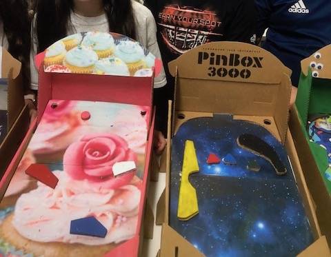 Students designed cardboard pinball machines as a STEM project.