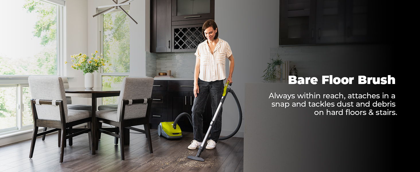 Person vacuuming a floor with a bare floor brush in a modern room.