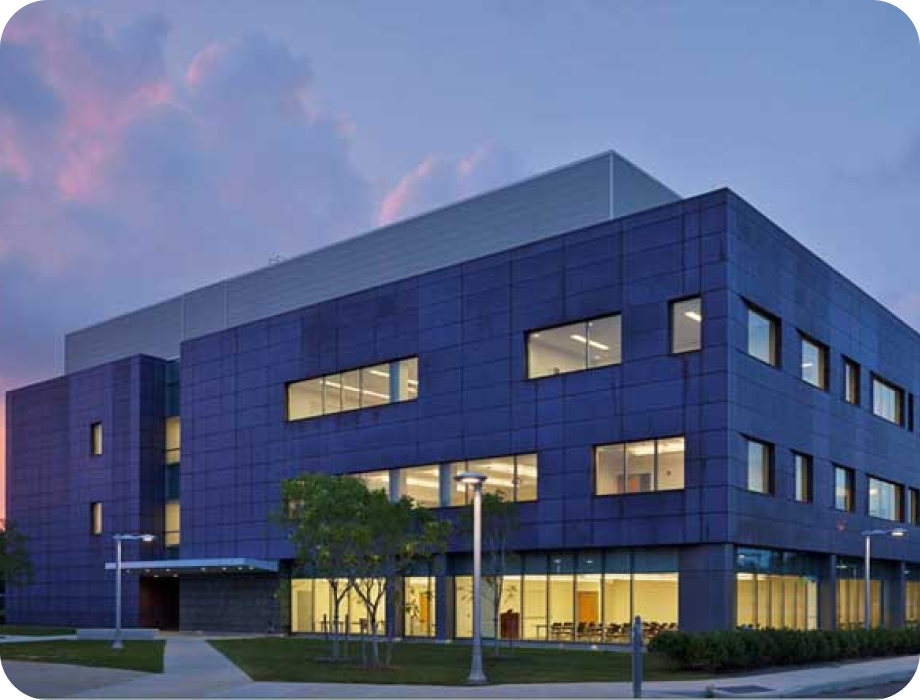 Modern blue building with large windows during twilight.