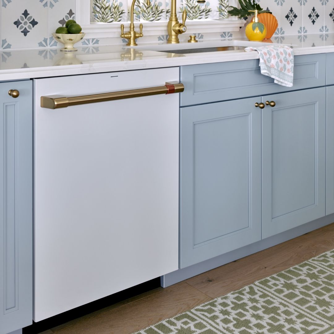 CAFE matte white dishwasher and light blue cabinetry.