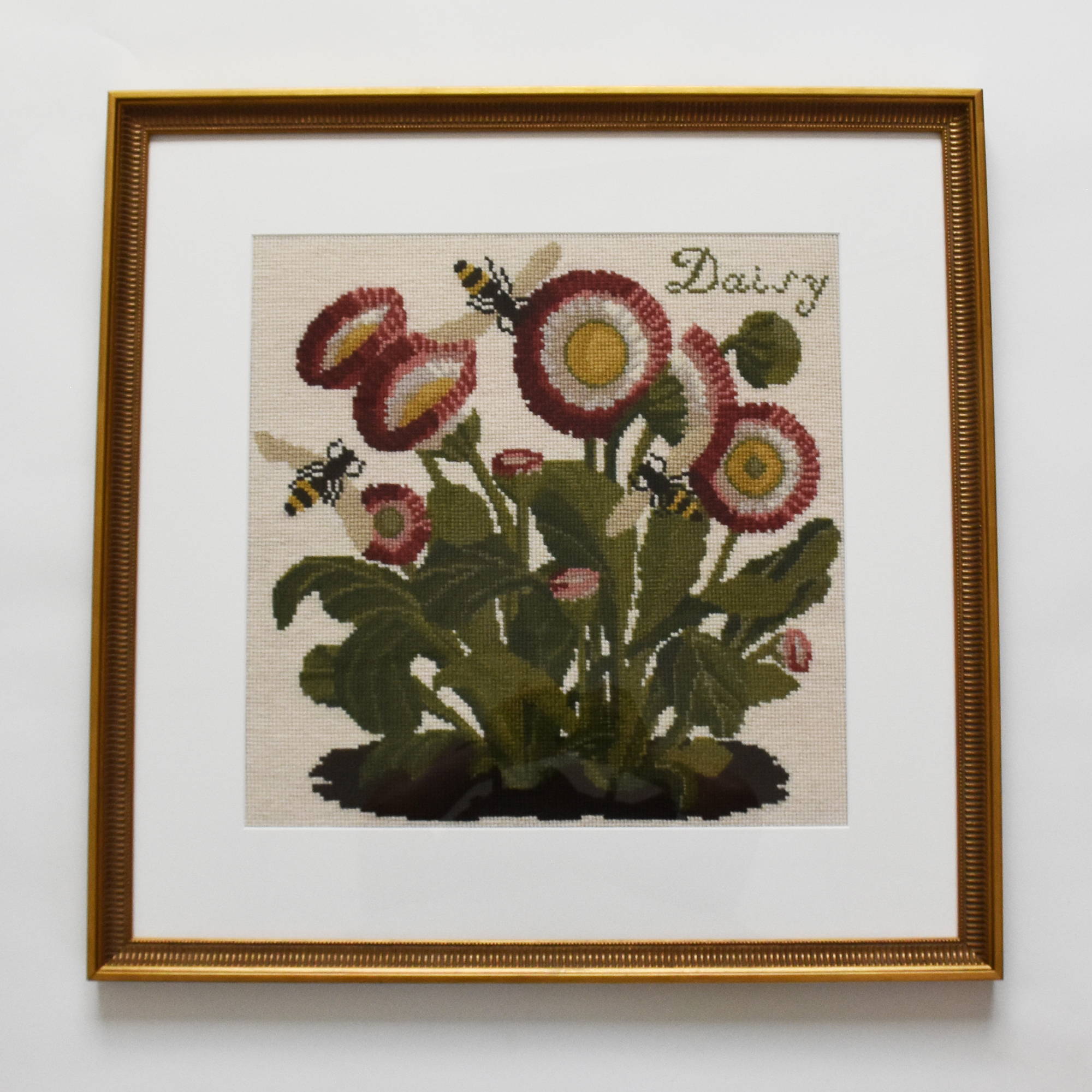 The Daisy Needlepoint kit framed with an antiqued gold frame