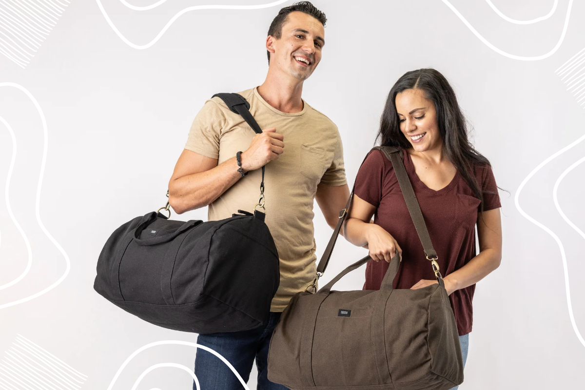 A man and woman holding Bumi Eco Duffel Bags from Terra Thread