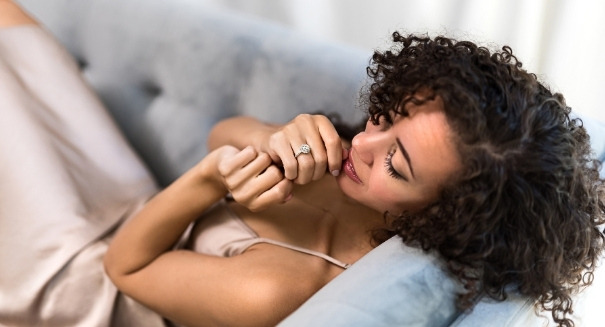 a woman trying on an engagement ring from the comfort of home