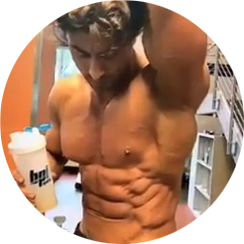Male bodybuilder posing while holding a BPI Sports shaker