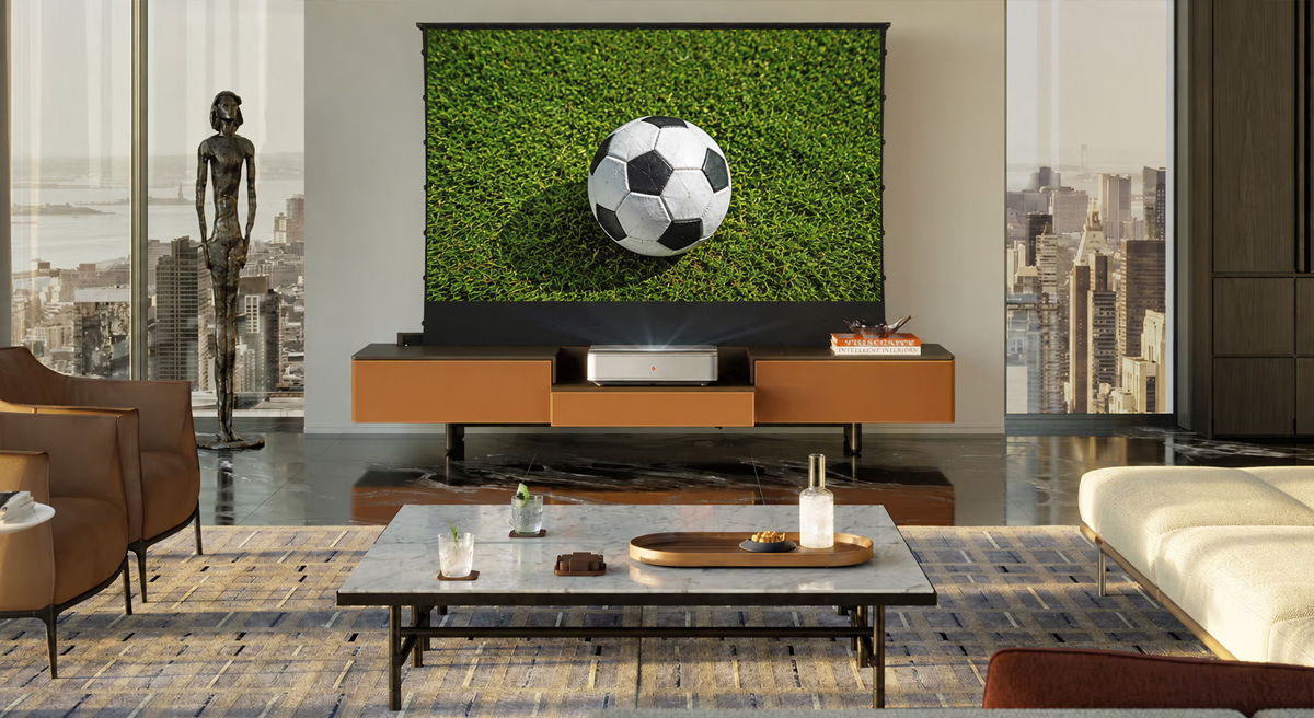 Modern living room with a television displaying a soccer ball on grass.