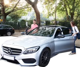 A couple standing beside a silver Mercedes car in a park setting.