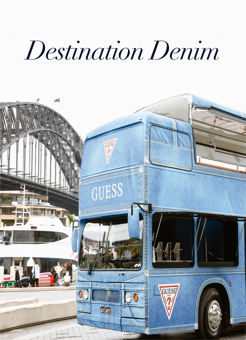 Blue double-decker bus near a bridge with 