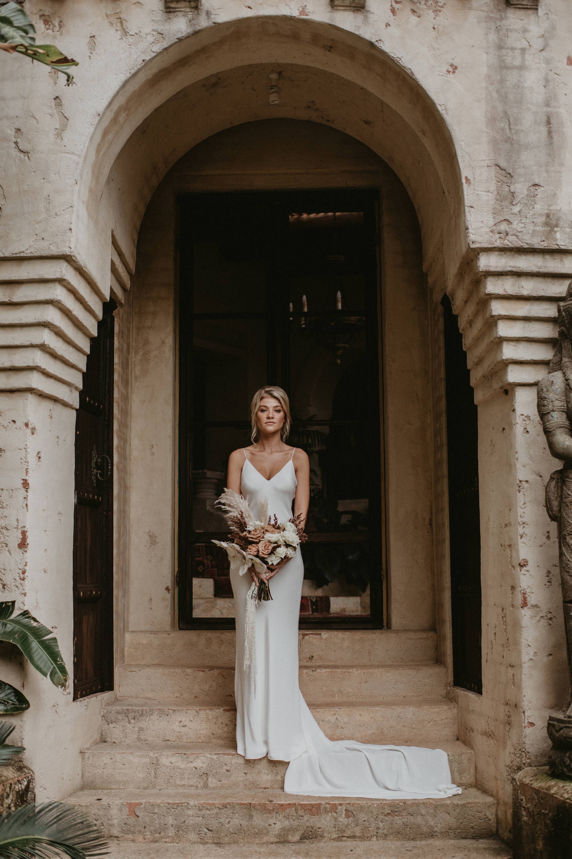 Grace Loves Lace bride wearing the Summer Silk gown underneath concrete arches