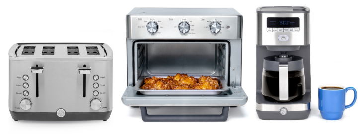 Three kitchen appliances: toaster, oven, coffee maker, with a blue coffee cup.