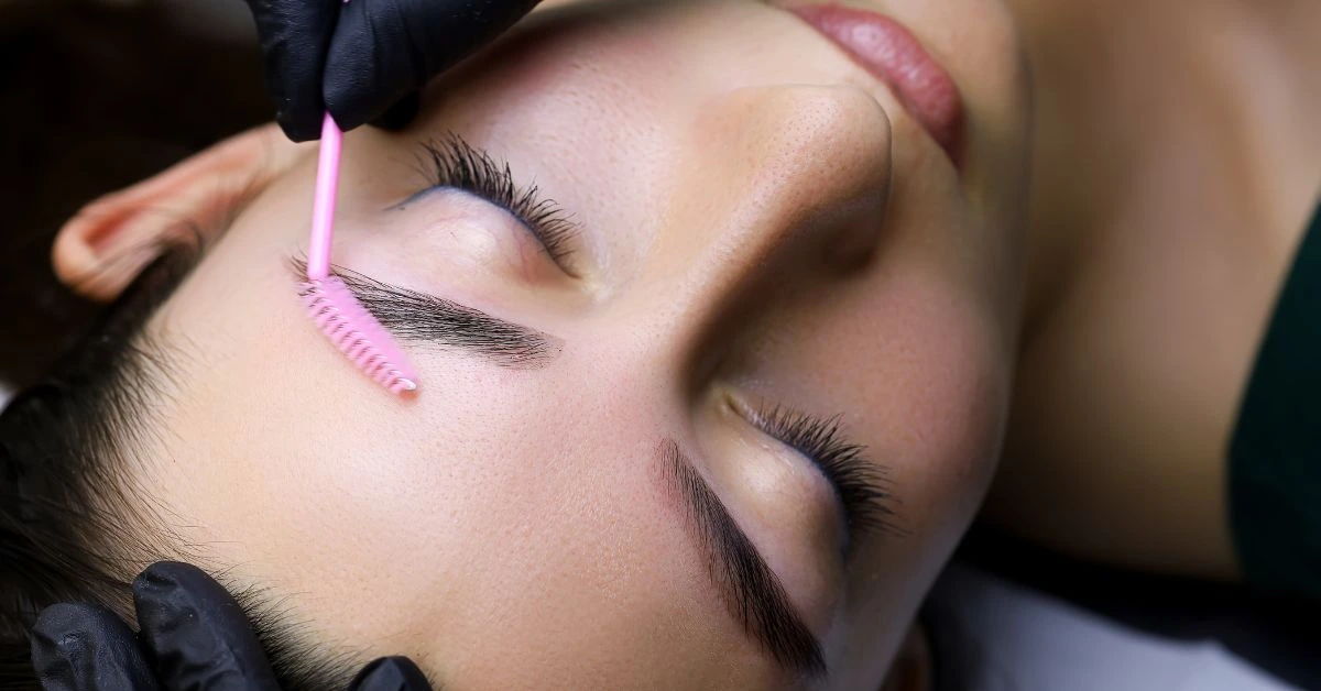 A person having their laminated brows brushed.