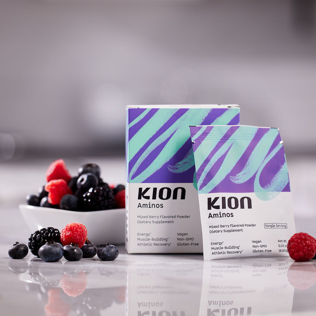 Kion Aminos product boxes with berries in a bowl.