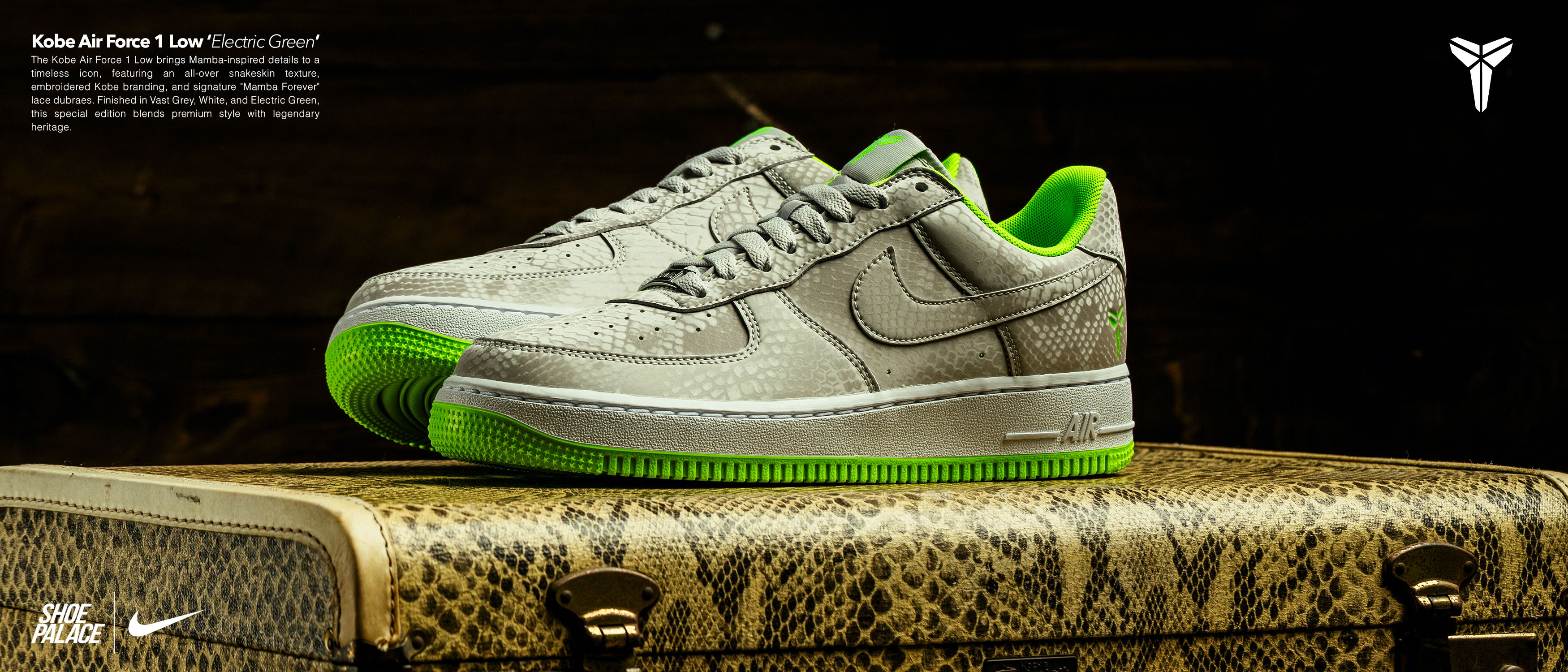 Nike Air Force 1 sneakers with green accents on a decorative surface.