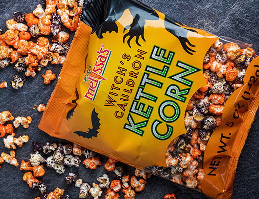 Bag of Witch's Cauldron Kettle Corn with scattered popcorn.