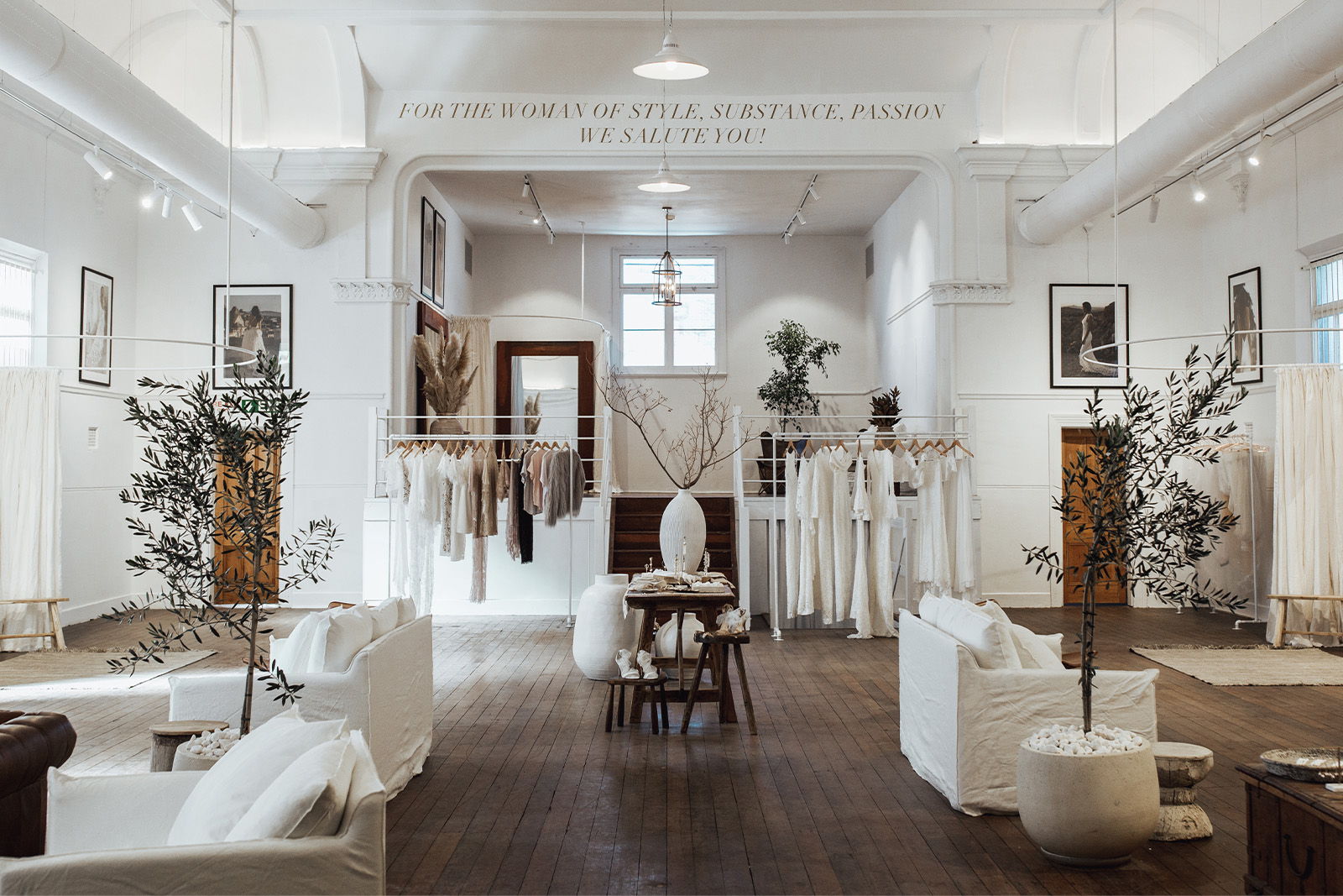 A stylish interior with white furniture and decorative plants.