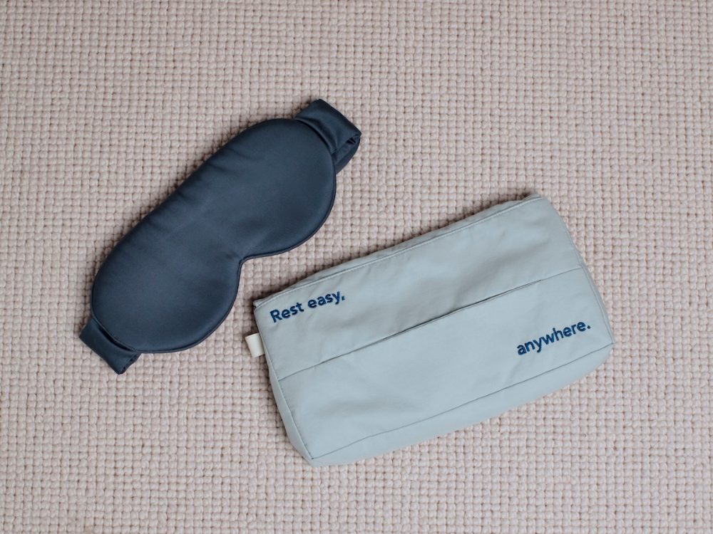 dark blue eye mask next to a cloth pouch