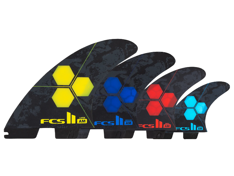 Four surfboard fins with colorful hexagonal designs on a black background.