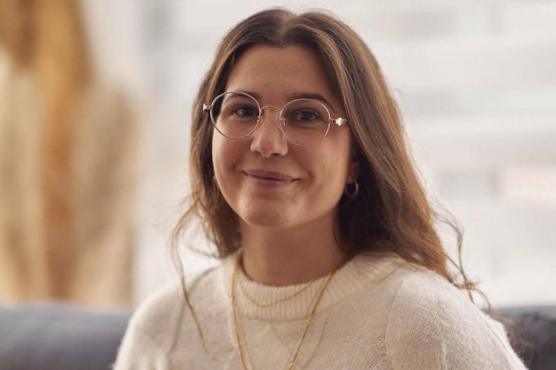 blonde woman wearing Joy Rose Gold neutral color eyeglasses