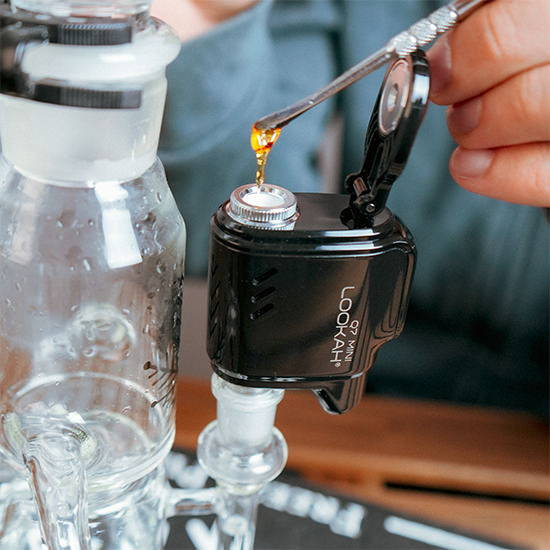 A man using a dab tool with his glass dab rig