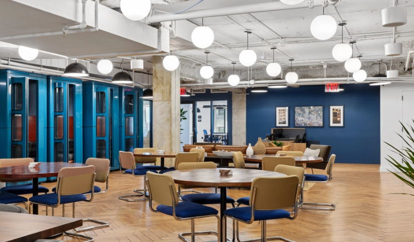 Modern office interior with seating areas and decorative lighting.