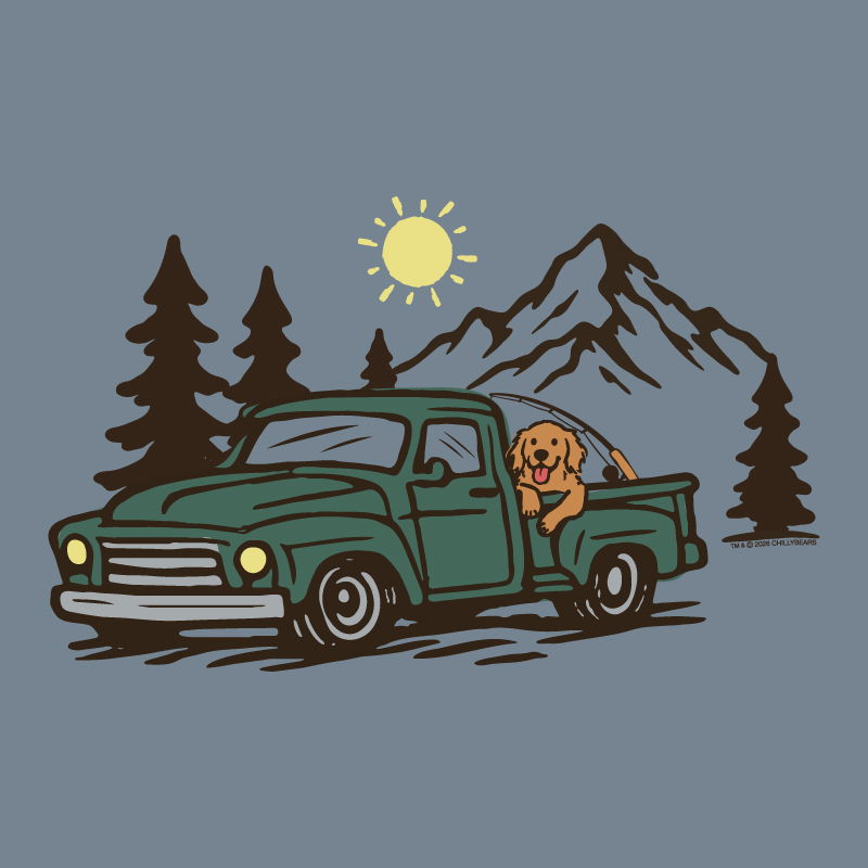 Dog in the back of a truck in front of a mountain