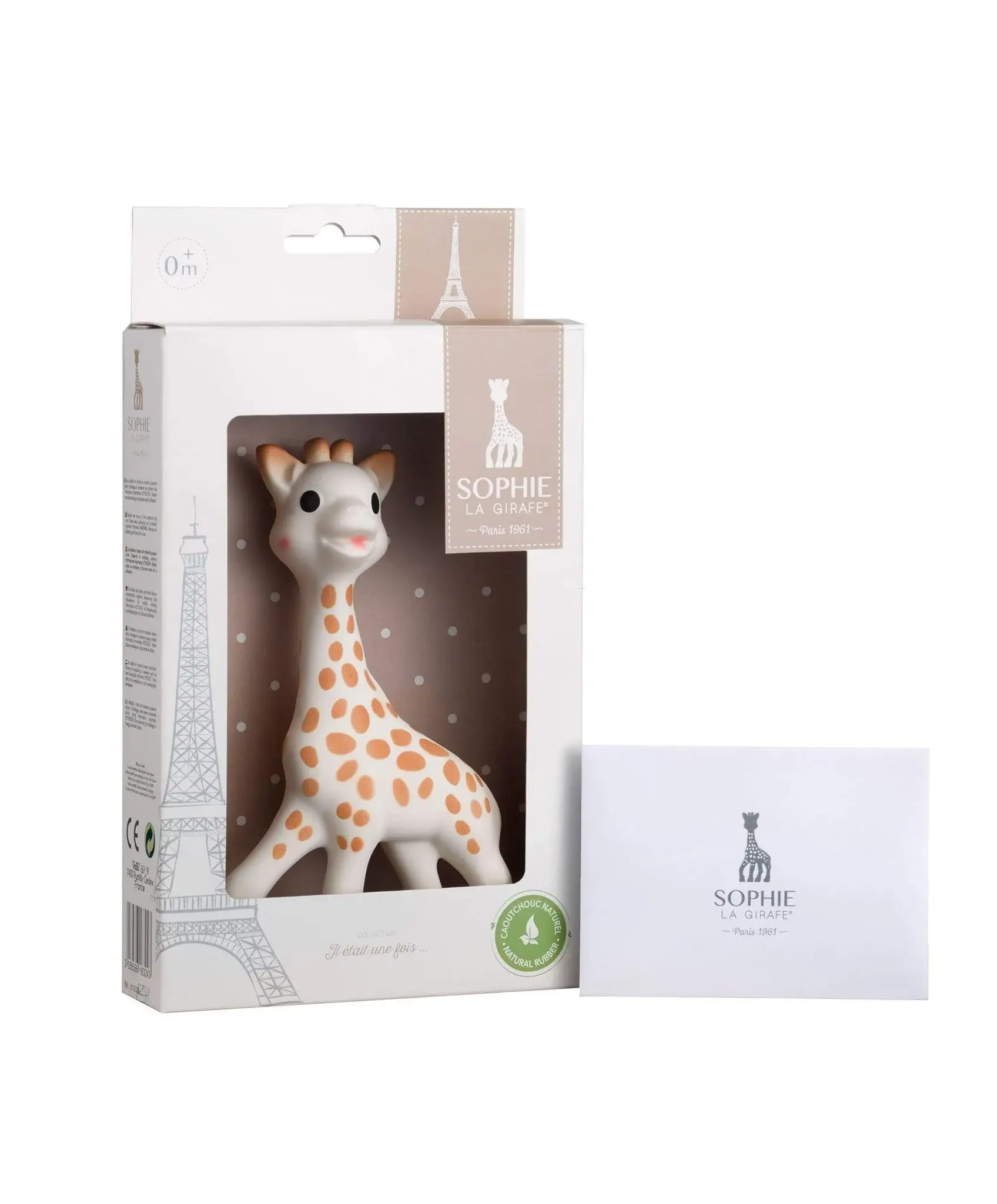 Giraffe toy in packaging with a card beside it.