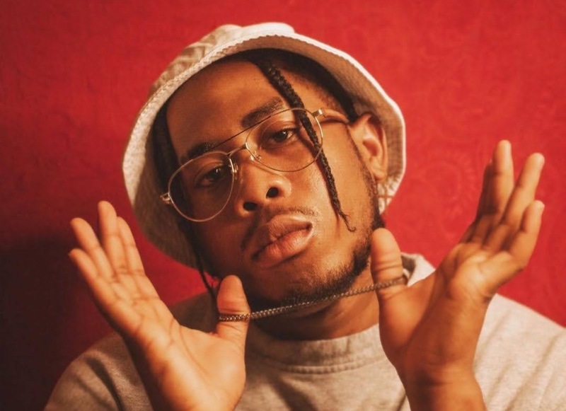 hipster man wearing Purpose Gold eyeglasses on a red background
