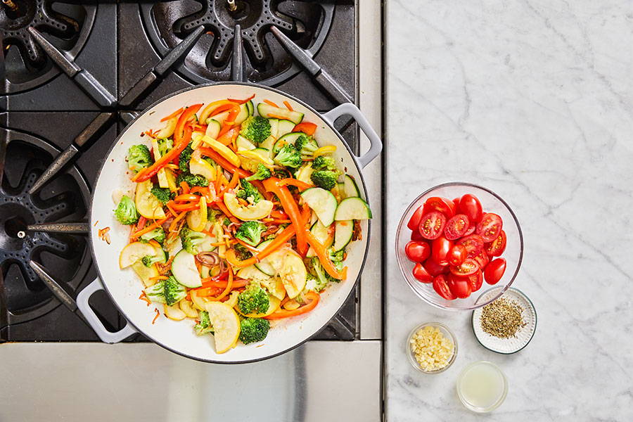 Squash and zucchini added to pan.