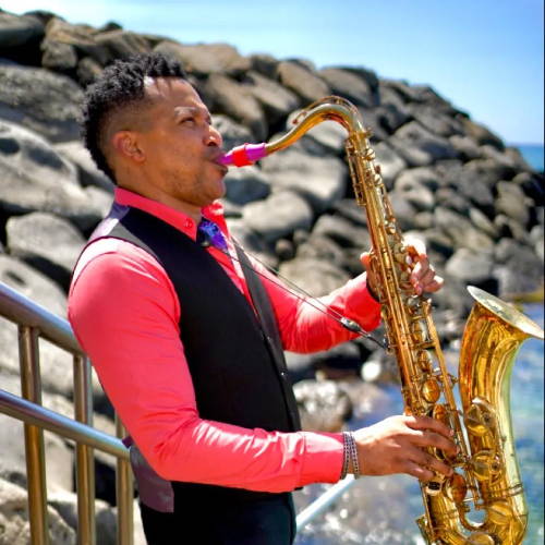 Jason Gay playing tenor saxophone by sea