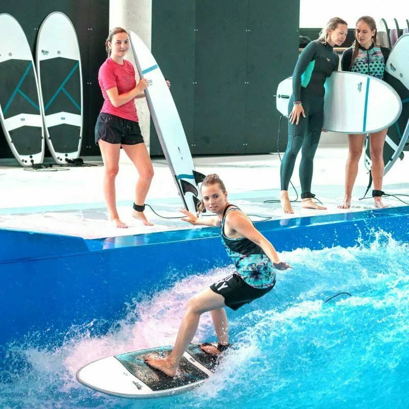 Group of people surfing at the wellenwerk with KANOA Performance foamie Surfboards