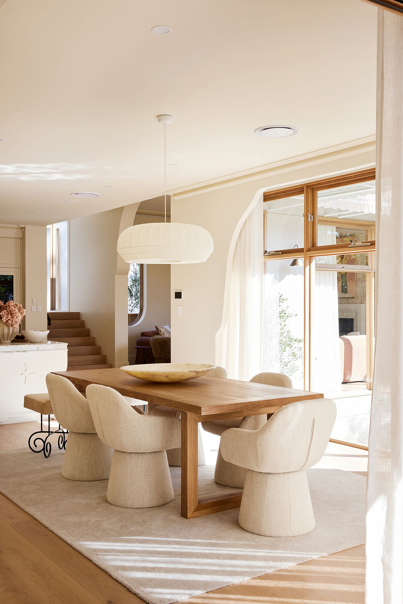 Modern dining room with a wooden table and stylish chairs.