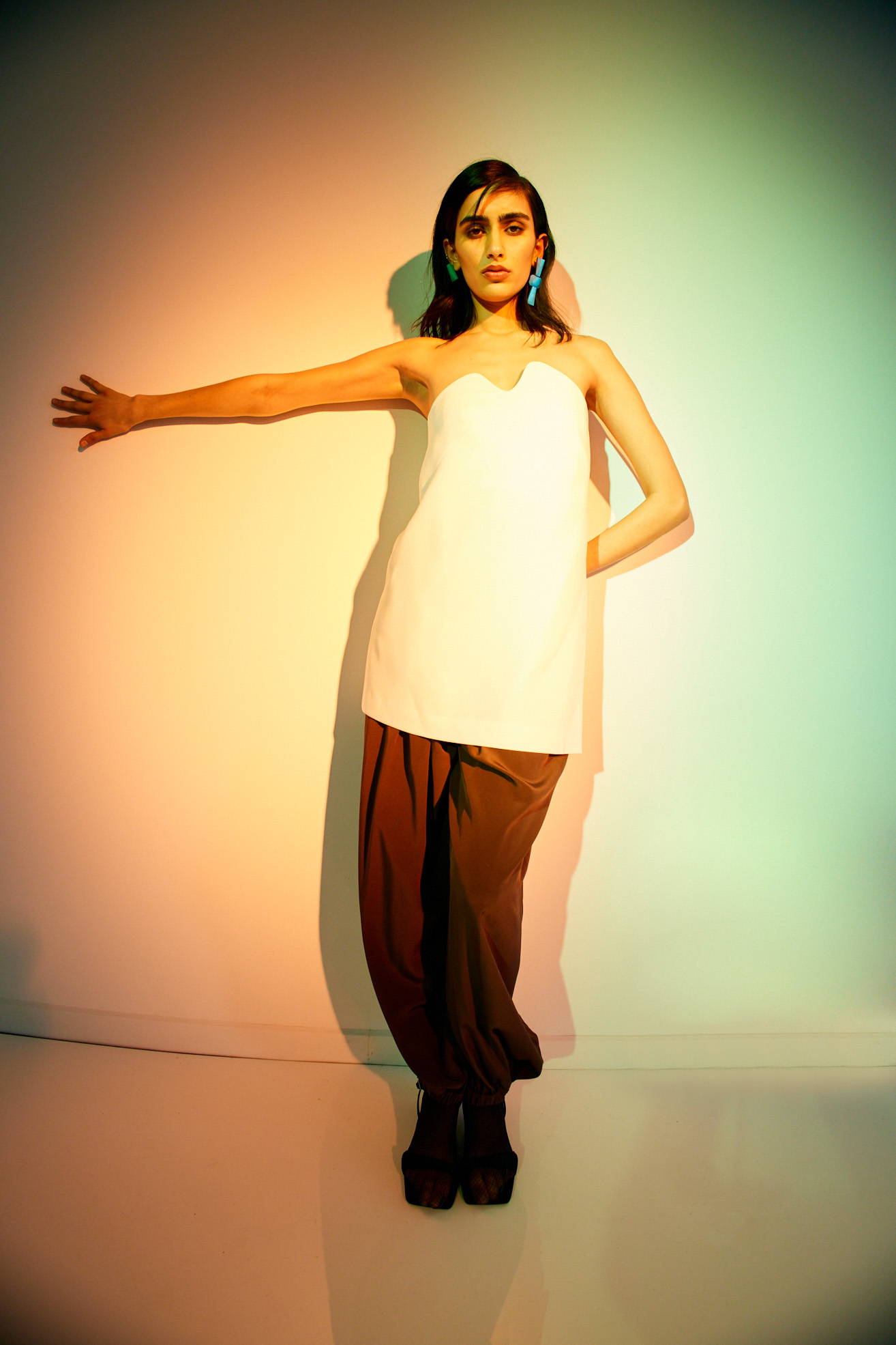 model standing on white background warm lighting