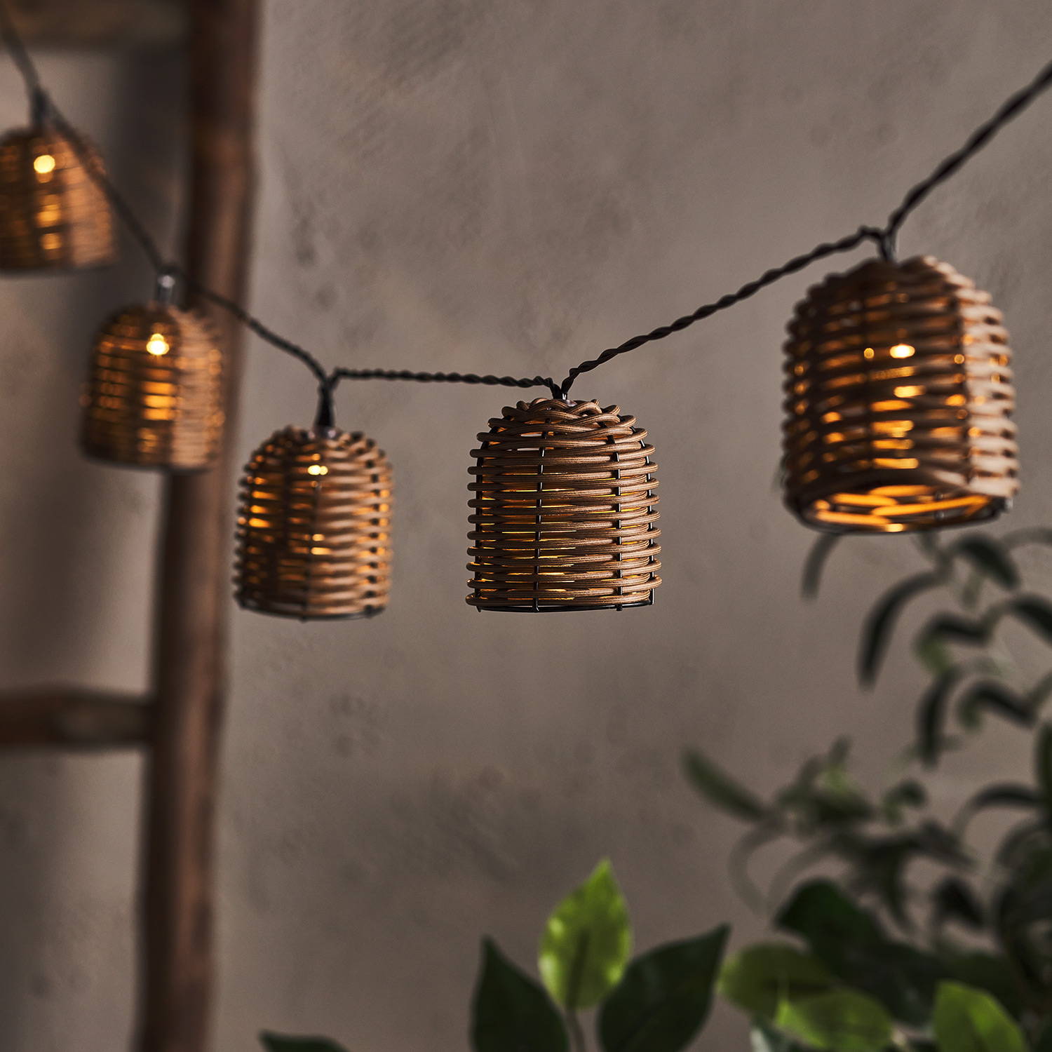 Guirlande lumineuse solaire en forme de lanterne suspendue en hauteur dans le jardin. 