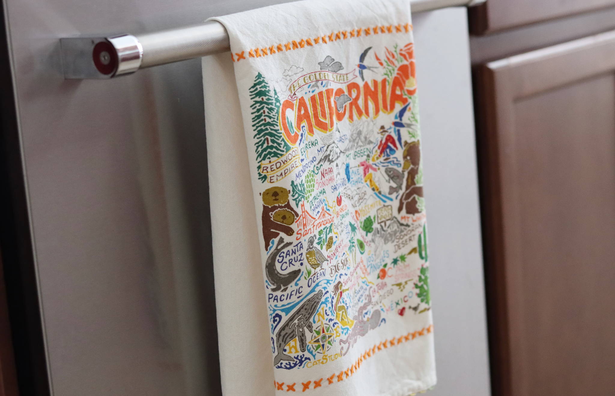 California embroidered dish towel hanging on kitchen towel bar