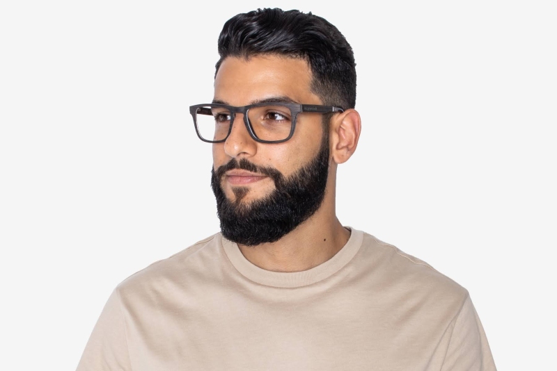 man wearing Bold Black hypoallergenic wooden glasses frames on a white background