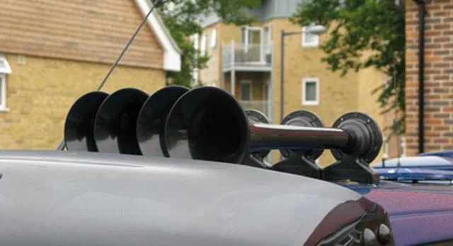 Close-up four glossy black Shocker XL train horn trumpets mounted on silver roof residential background Will's 1993 Eurovan gallery photo 2