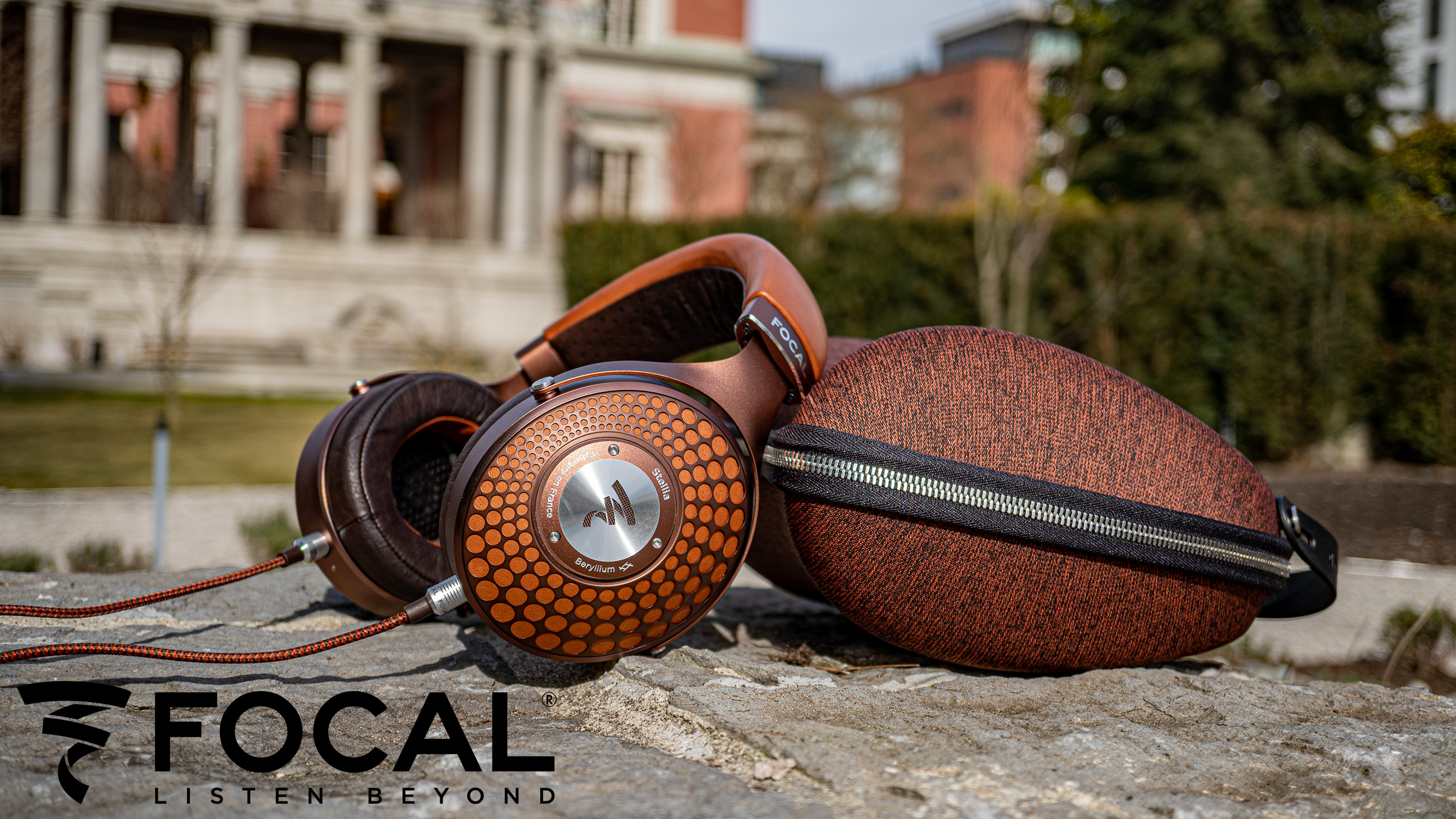 Focal Stellia Closed-Back Headphones with Carrying Case in front of Peter Wells' Mansion