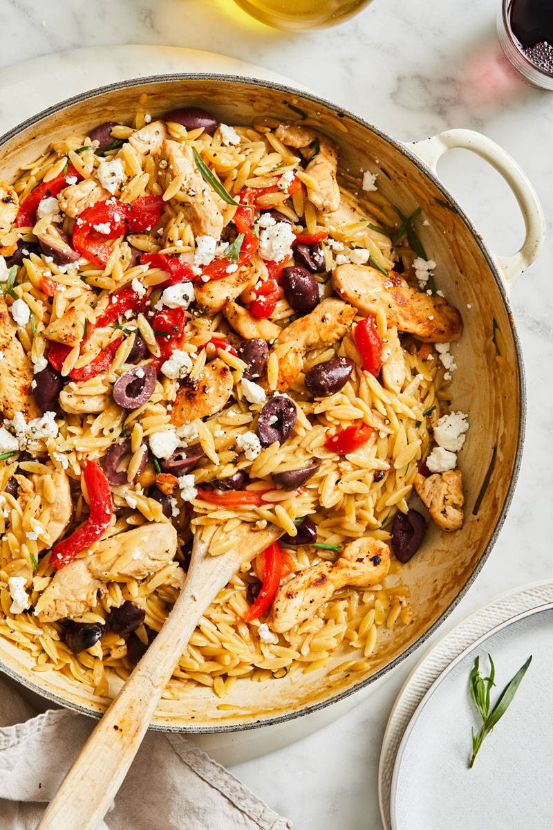 Orzo pasta tossed with red pepper strips, olives, feta and grilled chicken in a creamy cheesy sauce and prepared in a pot