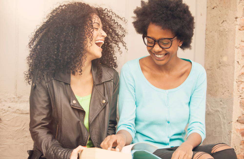 two women friends sitting down laughing|choose good friends for mental ly strong and  keep brain in peak condition